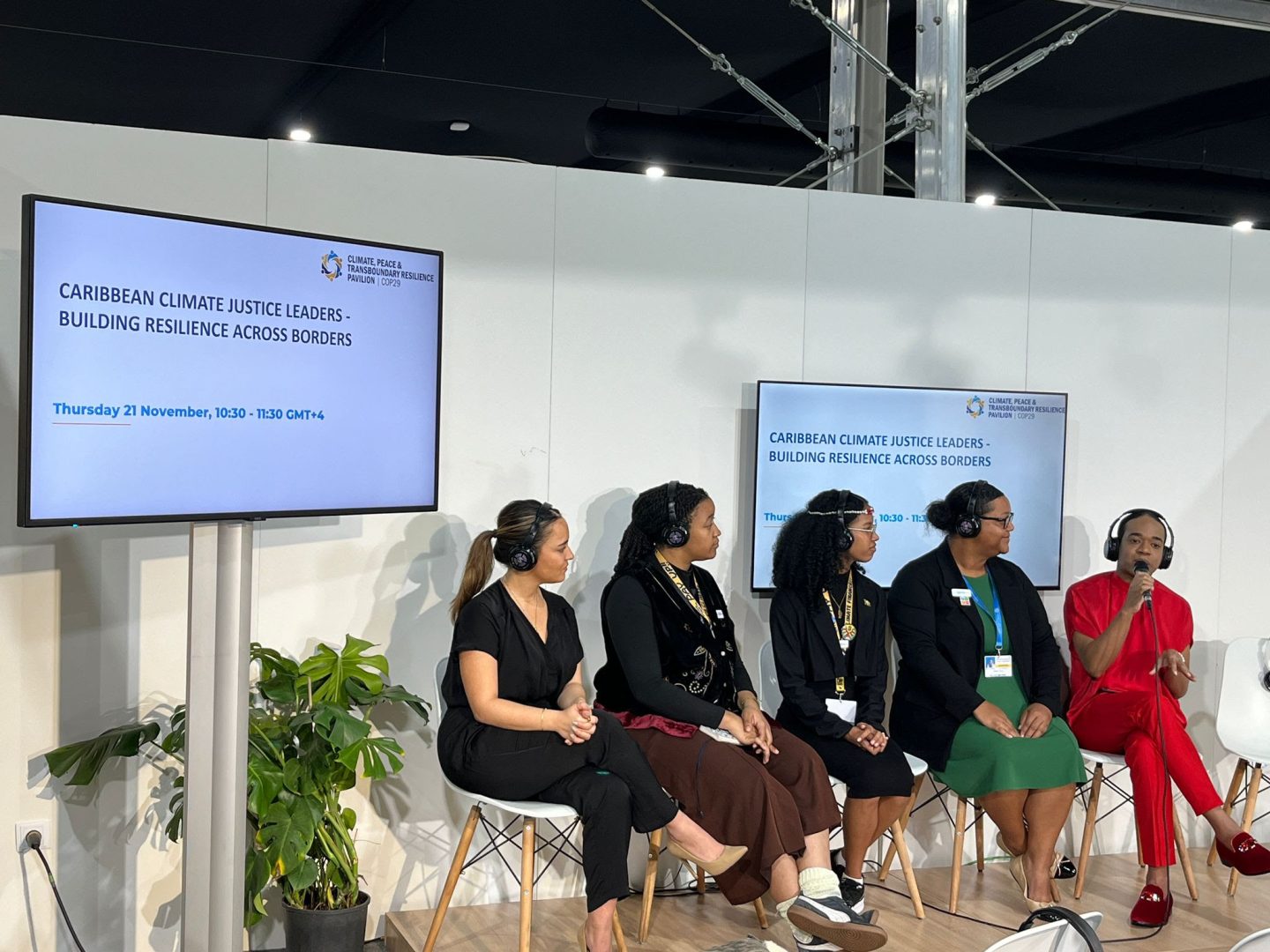 People attending a panel session at COP29